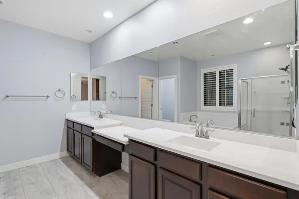 a bathroom with a sink double vanity and a mirror