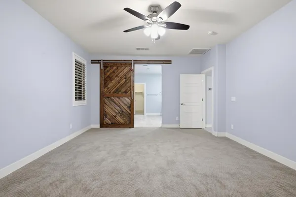 an empty room with a empty space and a ceiling fan