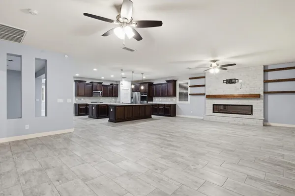a view of a kitchen with a stove cabinets wooden floor and a kitchen