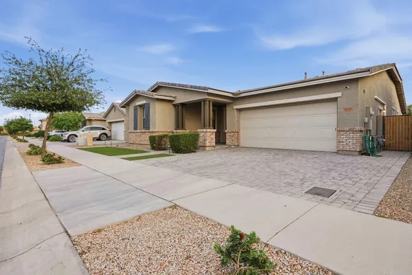a front view of a house with a yard and garage