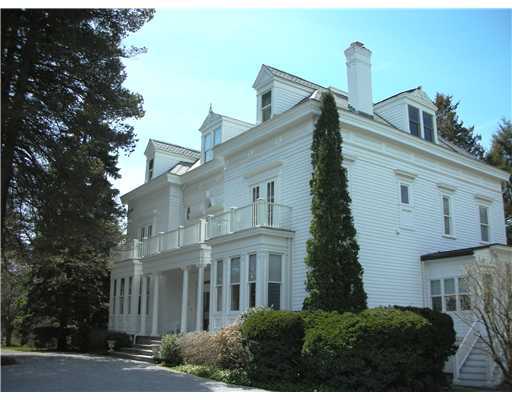 Undisclosed Address Darien, CT 06820 - Photo 1 of 20 a view of a white building among the street with palm trees