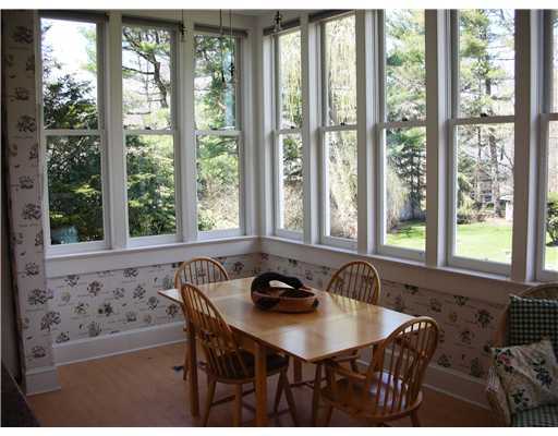 Undisclosed Address Darien, CT 06820 - Photo 11 of 20 a view of a dining room with furniture window and outside view