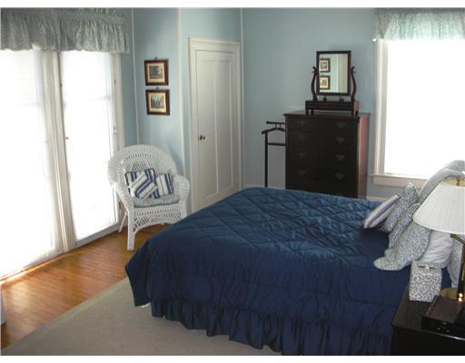 Undisclosed Address Darien, CT 06820 - Photo 18 of 20 a bedroom with a bed and a painting on the wall