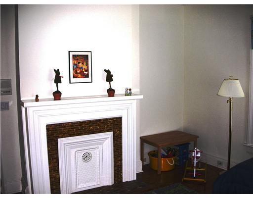 Undisclosed Address Darien, CT 06820 - Photo 20 of 20 a living room with a fireplace and a table