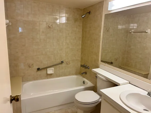 a bathroom with a toilet a sink and bathtub