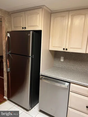 a white refrigerator freezer sitting inside of a kitchen