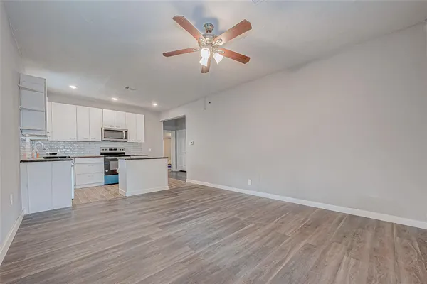 a view of kitchen with refrigerator microwave and stove