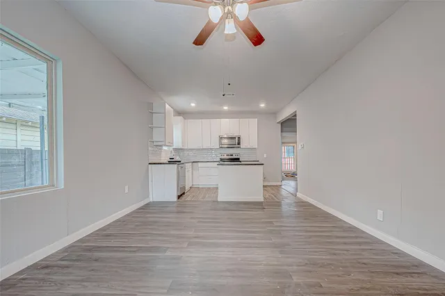 a view of kitchen with wooden floor and window