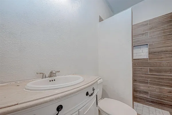 a bathroom with a sink a toilet and mirror