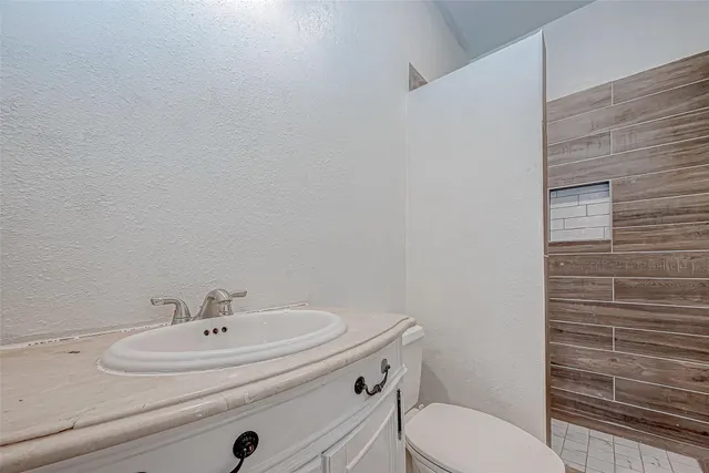 a bathroom with a sink a toilet and mirror