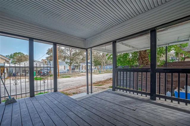 a view of a balcony with wooden floor