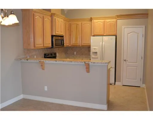 a kitchen with cabinets and stainless steel appliances