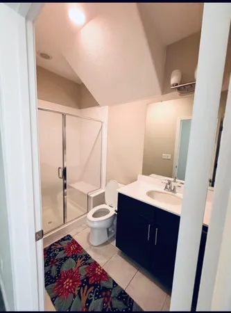a bathroom with a sink vanity mirror and toilet