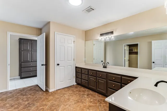 a bathroom with double sinks a double vanity and a mirror