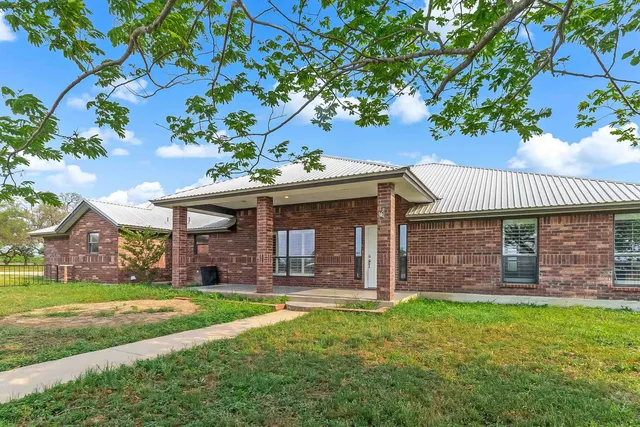 front view of a house with a yard