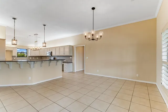 a view of a kitchen with stainless steel appliances granite countertop a sink and cabinets