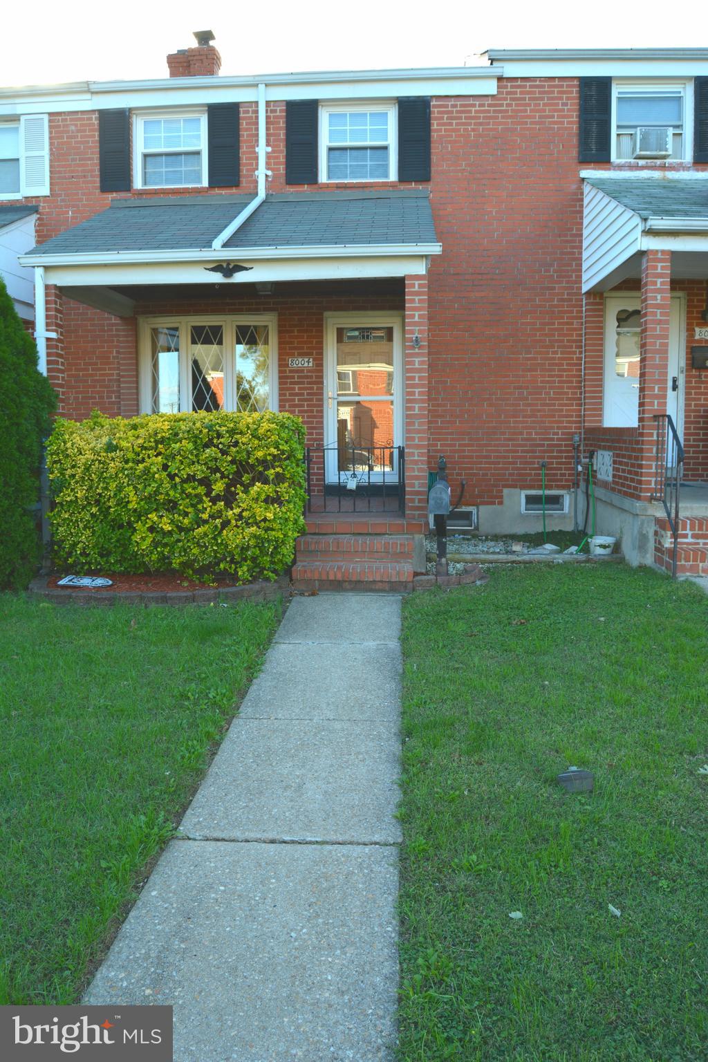8004 Charlesmont Road Baltimore, MD 21222 - Photo 1 of 18 a front view of a house with garden