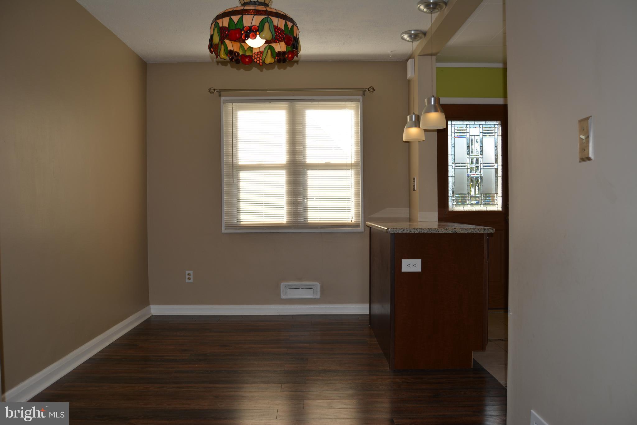 8004 Charlesmont Road Baltimore, MD 21222 - Photo 11 of 18 a view of a livingroom with wooden floor and windows