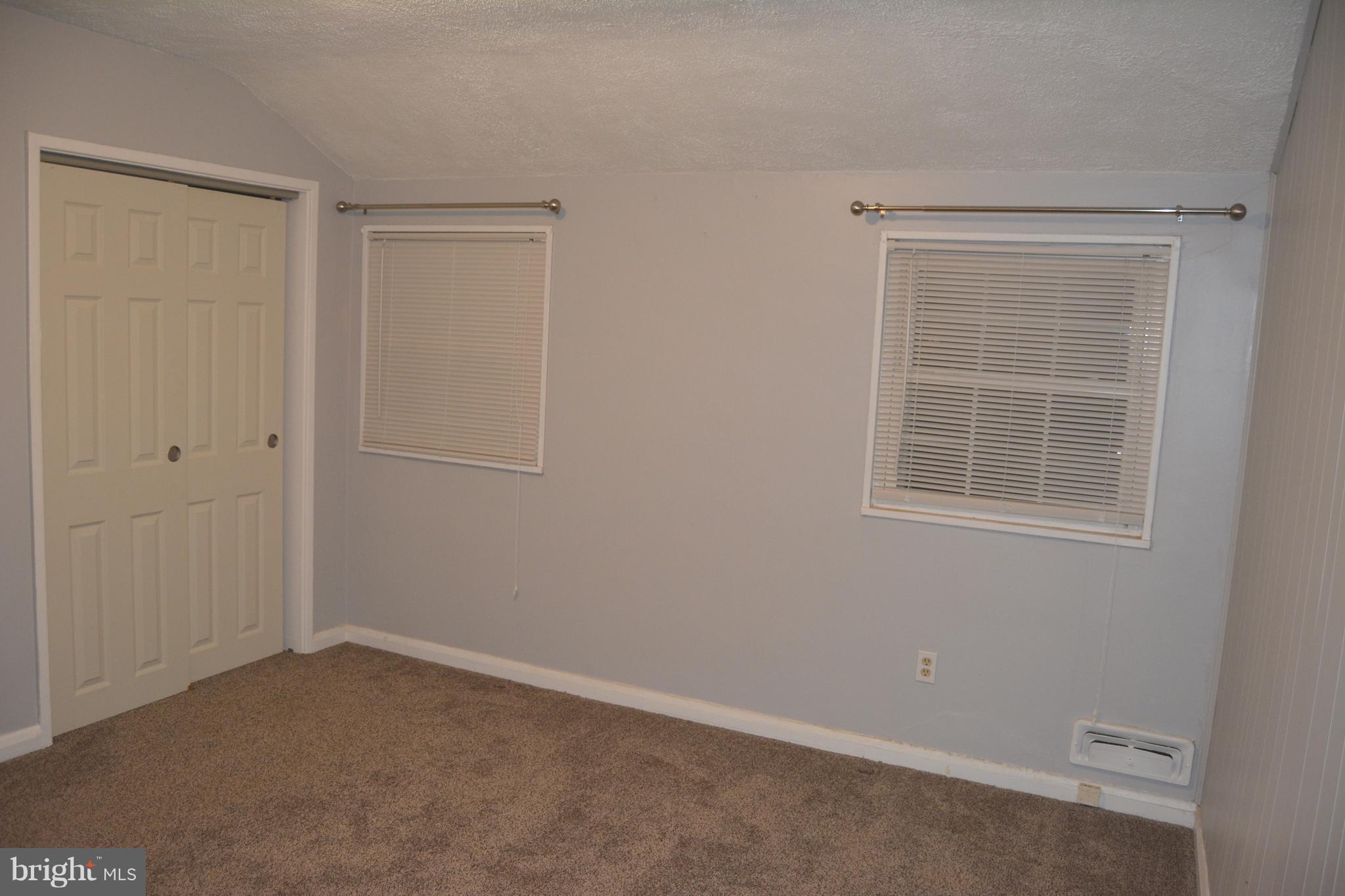 8004 Charlesmont Road Baltimore, MD 21222 - Photo 14 of 18 an empty room with windows