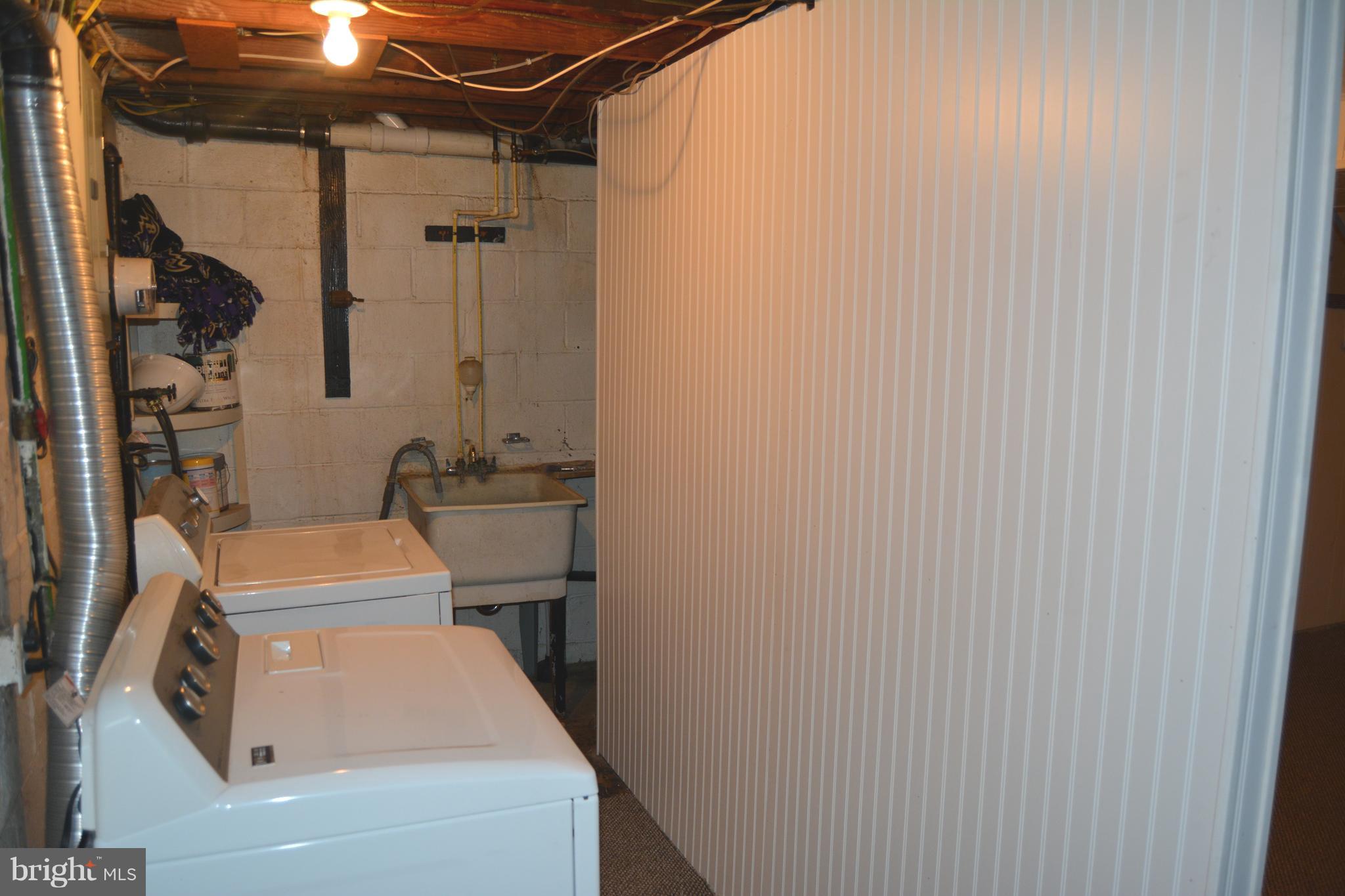 8004 Charlesmont Road Baltimore, MD 21222 - Photo 17 of 18 a bathroom with a sink a toilet and shower