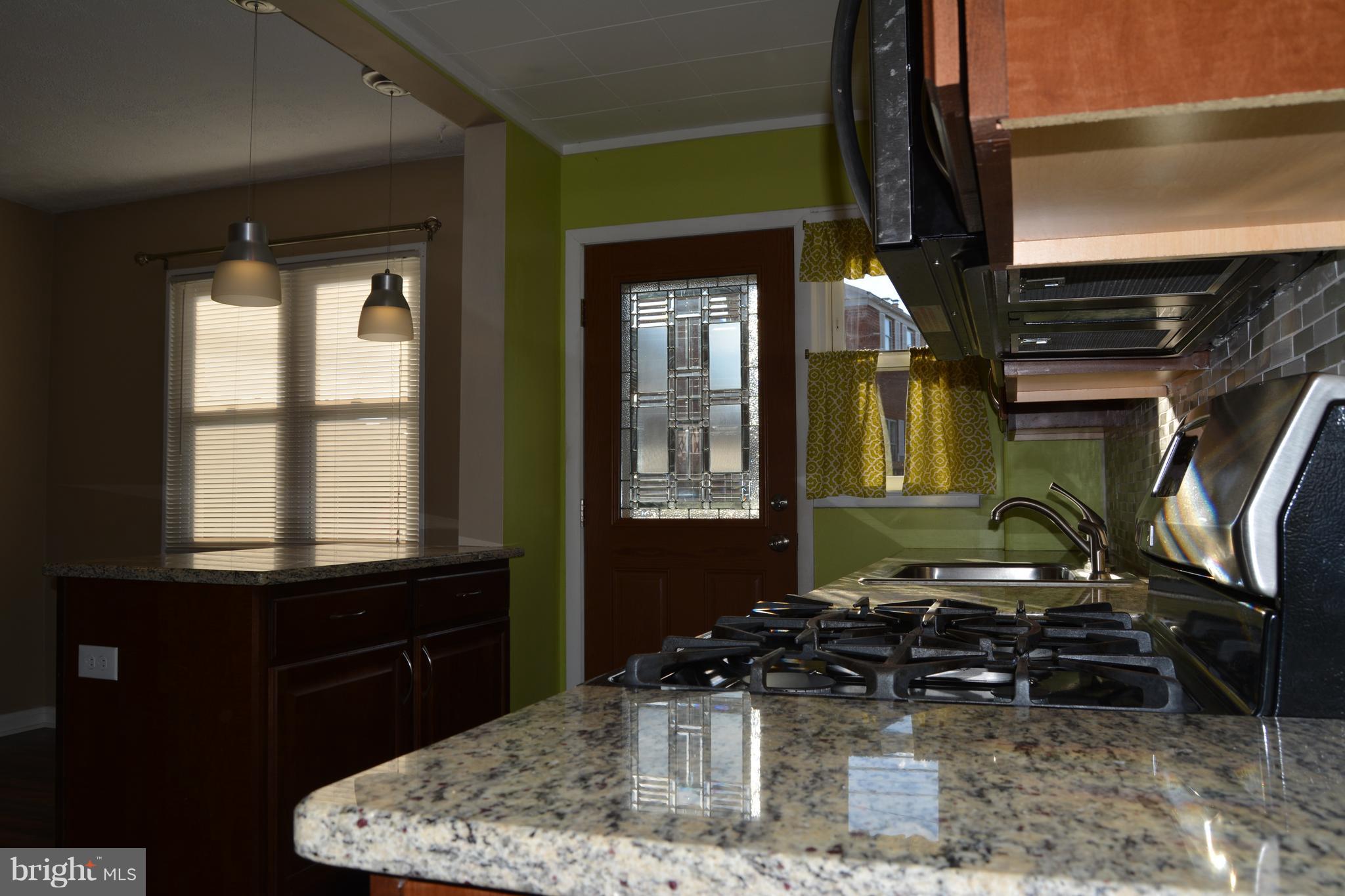 8004 Charlesmont Road Baltimore, MD 21222 - Photo 5 of 18 a bathroom with a sink a mirror and a window