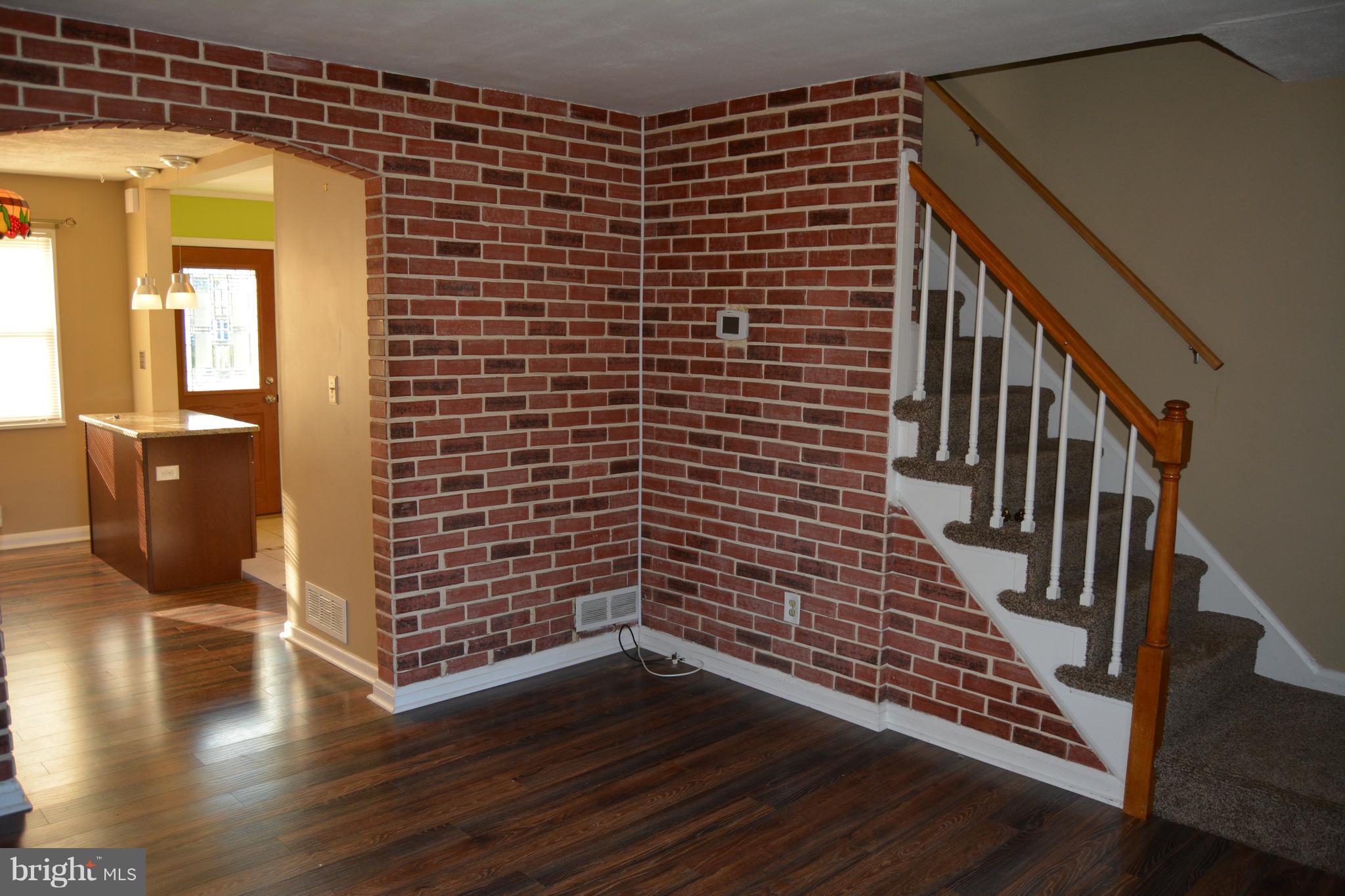 8004 Charlesmont Road Baltimore, MD 21222 - Photo 7 of 18 a view of wooden floor with staircase