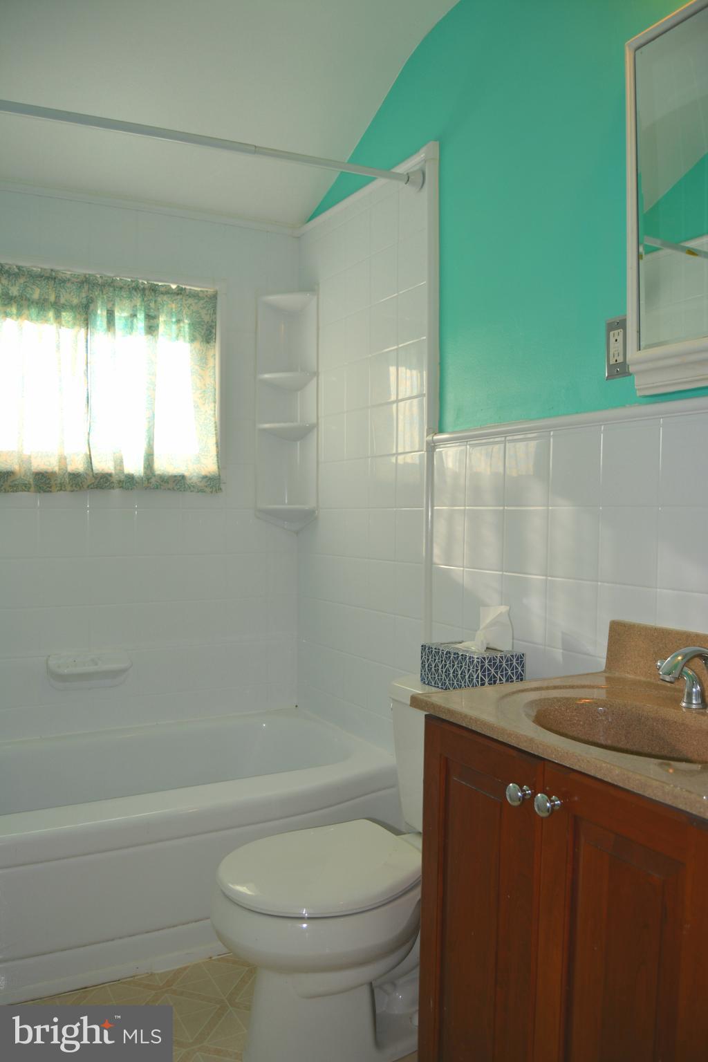 8004 Charlesmont Road Baltimore, MD 21222 - Photo 9 of 18 a bathroom with a granite countertop toilet a sink and bathtub