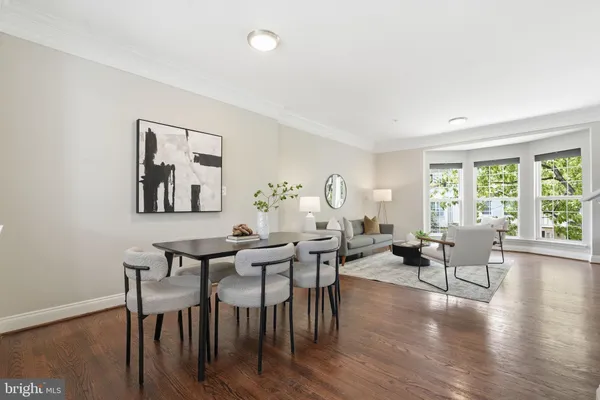 a view of a dining room with furniture and wooden floor
