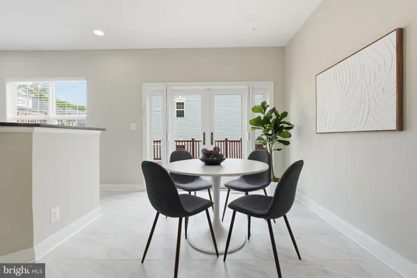 a dining room with furniture and a window