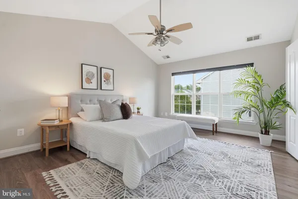 a large bedroom with a large bed and a window