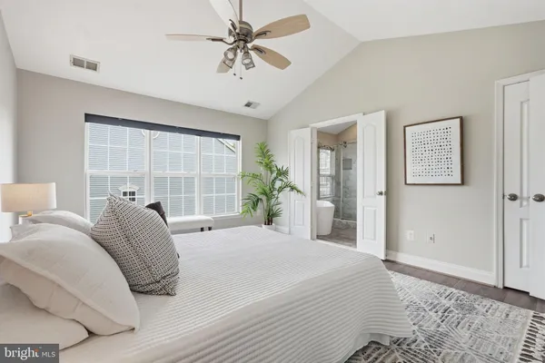 a bedroom with a bed and a potted plant