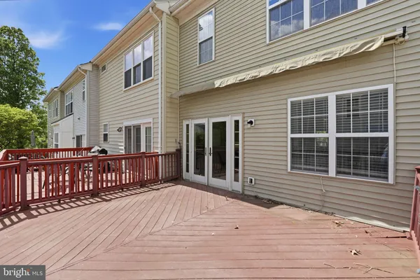a view of a house with backyard and deck