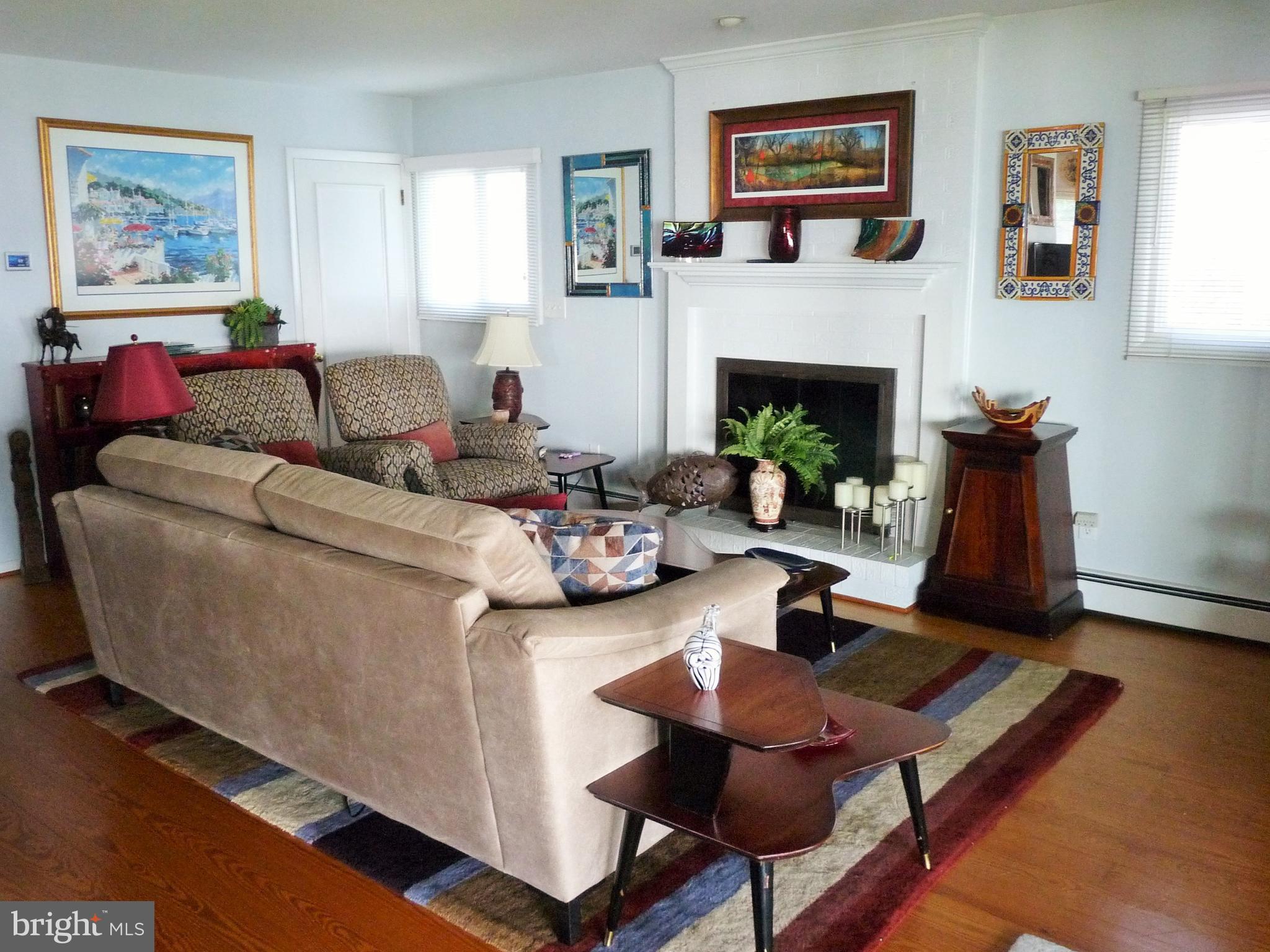 102 Point Road Stevensville, MD 21666 - Photo 20 of 41 Living room with fireplace and beautiful hardwoods