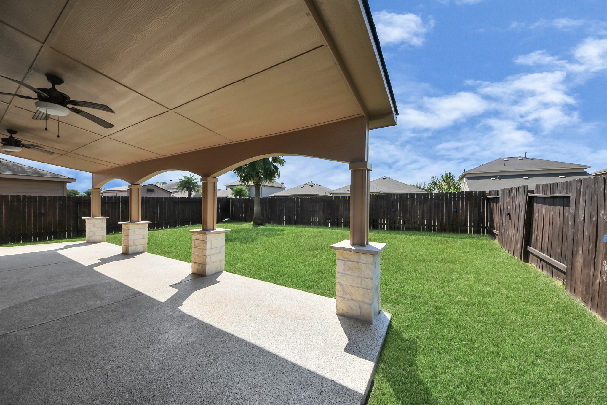6931 Primrose Road Baytown, TX 77521 - Photo 45 of 50 Spacious backyard with covered patio and plenty of green space for outdoor enjoyment.