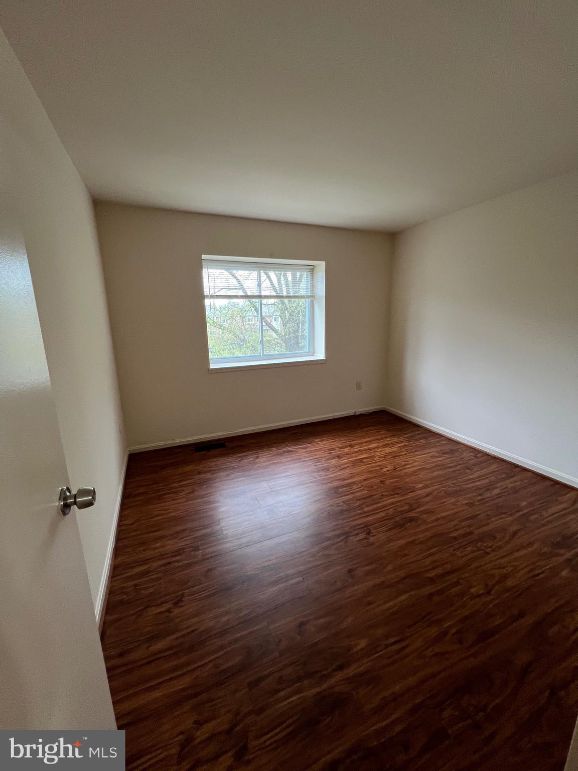 4645 Logsdon Drive Annandale, VA 22003 - Photo 14 of 20 an empty room with wooden floor and windows