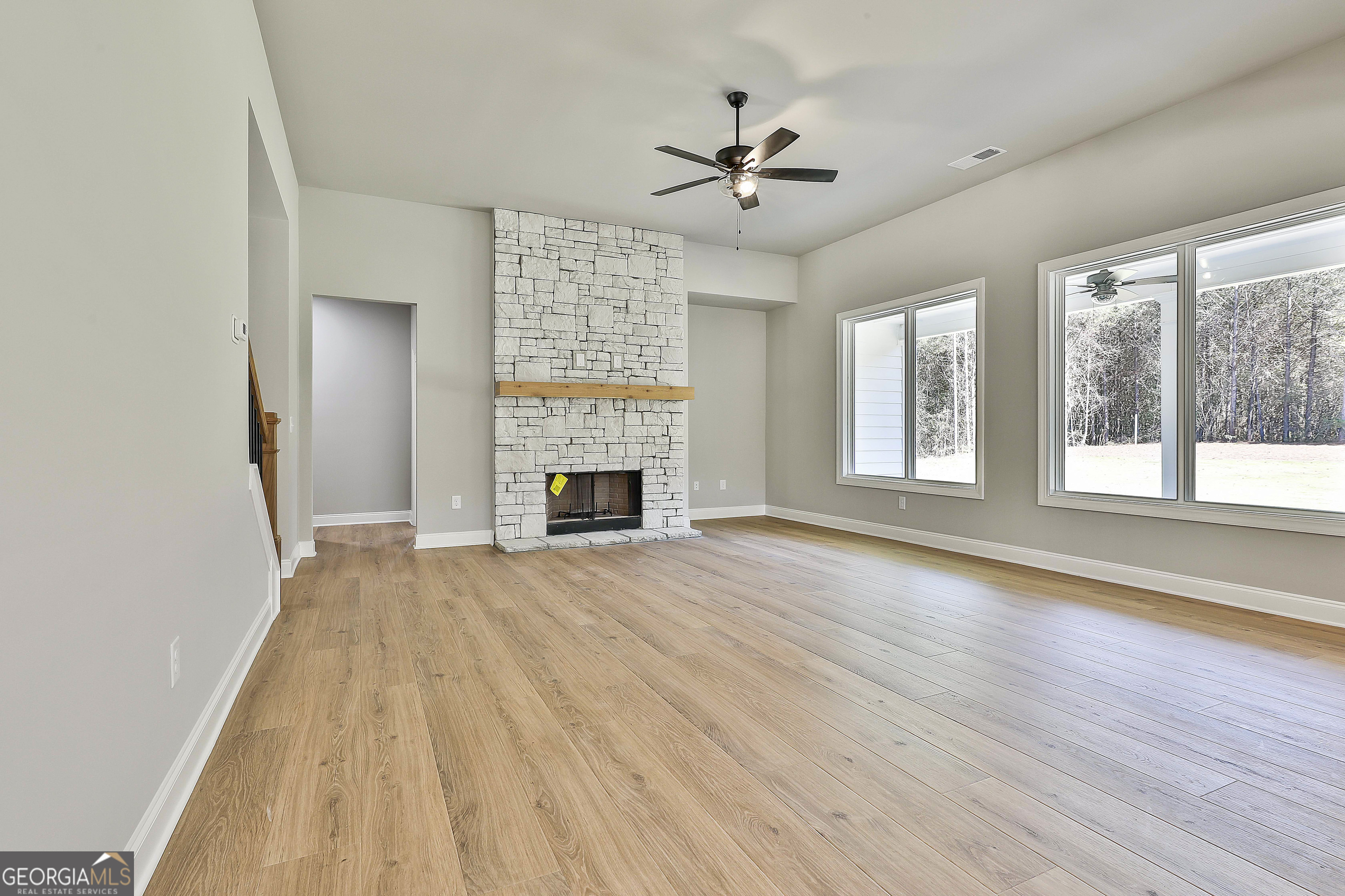 779 Alex Stephens Road Moreland, GA 30259 - Photo 13 of 54 a view of empty room with wooden floor and fan