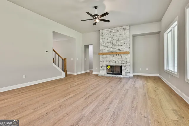 wooden floor in an empty room with a fireplace