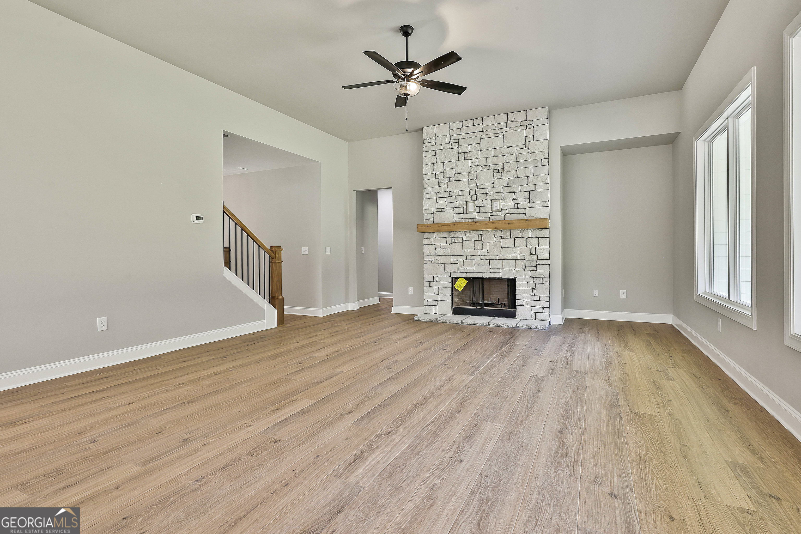 779 Alex Stephens Road Moreland, GA 30259 - Photo 14 of 54 wooden floor in an empty room with a fireplace