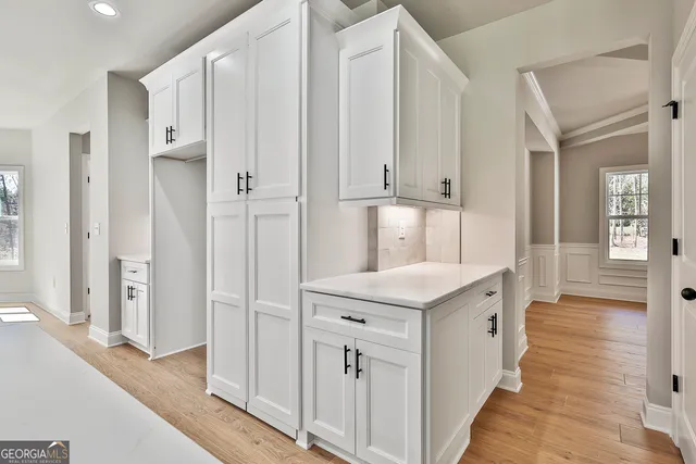 a kitchen with white cabinets appliances and sink