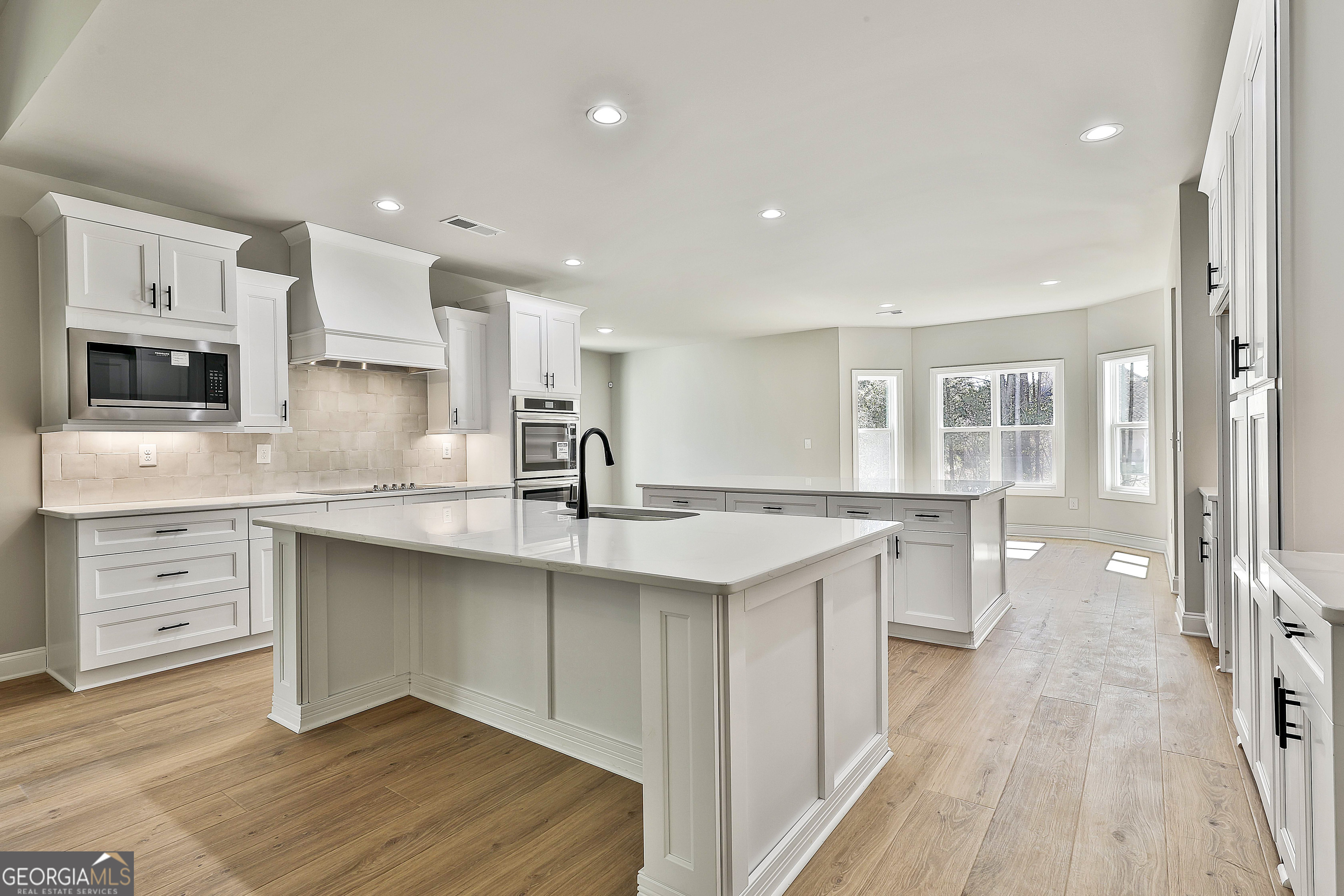 779 Alex Stephens Road Moreland, GA 30259 - Photo 18 of 54 a kitchen with white cabinets appliances and sink