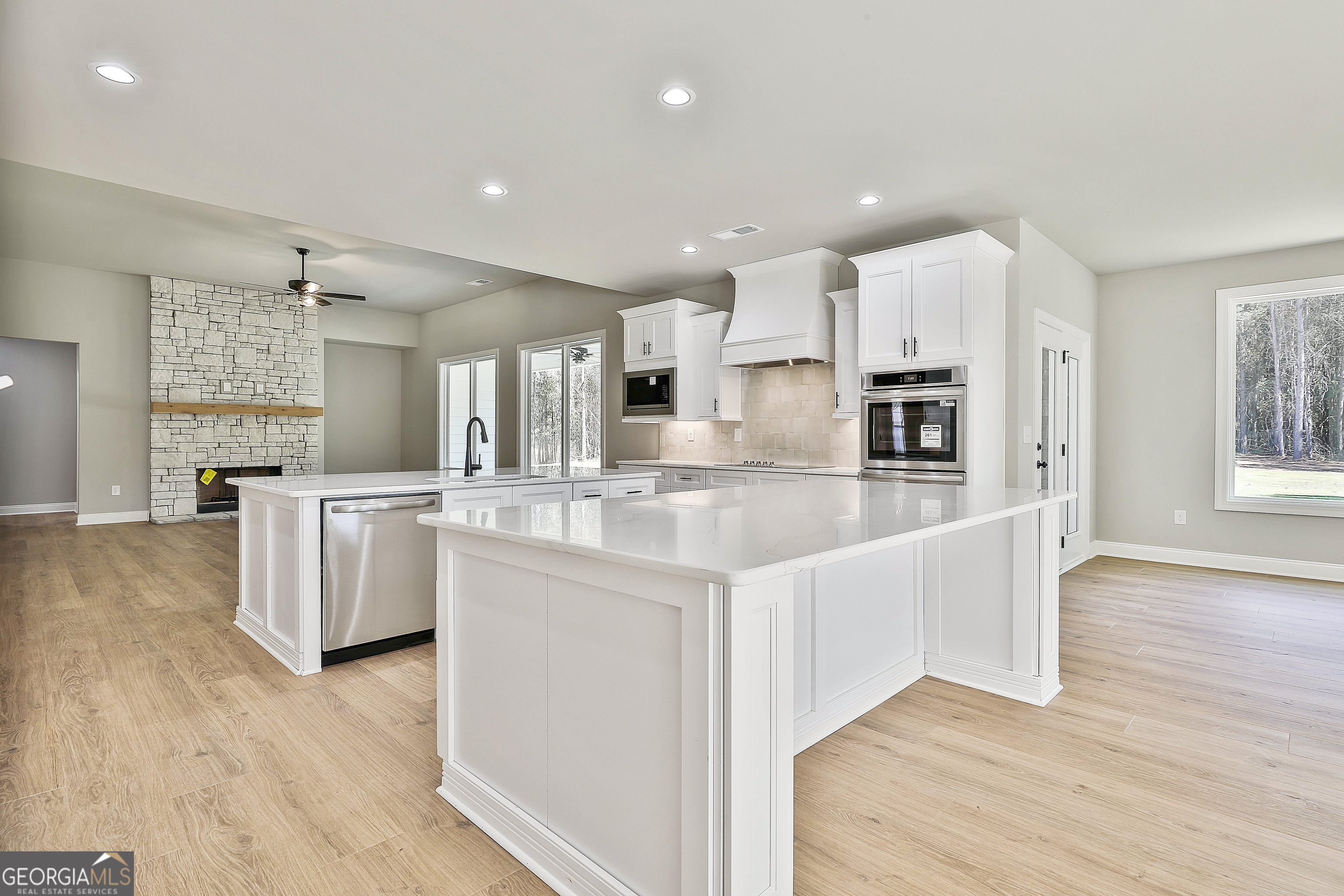 779 Alex Stephens Road Moreland, GA 30259 - Photo 23 of 54 a large white kitchen with kitchen island and stainless steel appliances