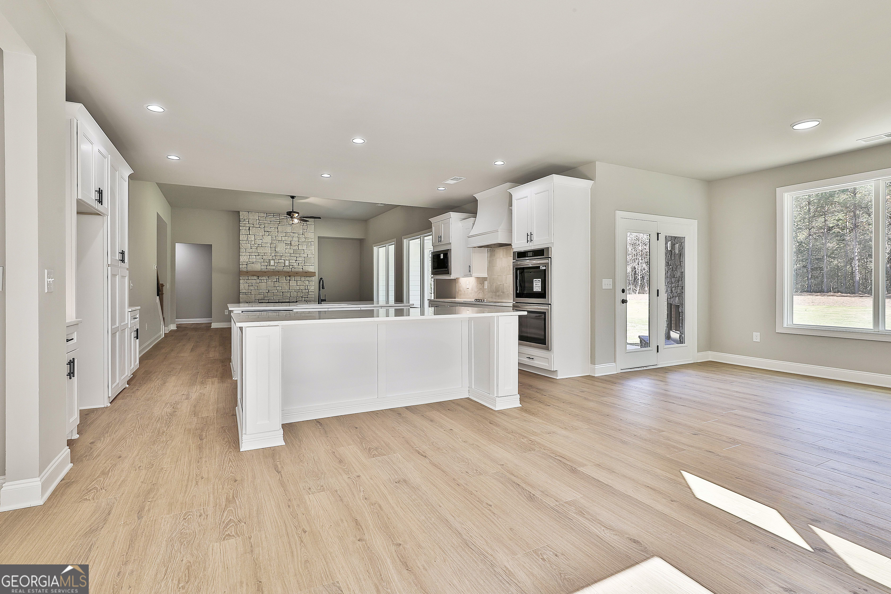 779 Alex Stephens Road Moreland, GA 30259 - Photo 25 of 54 a large kitchen with stainless steel appliances kitchen island a large counter top and a refrigerator