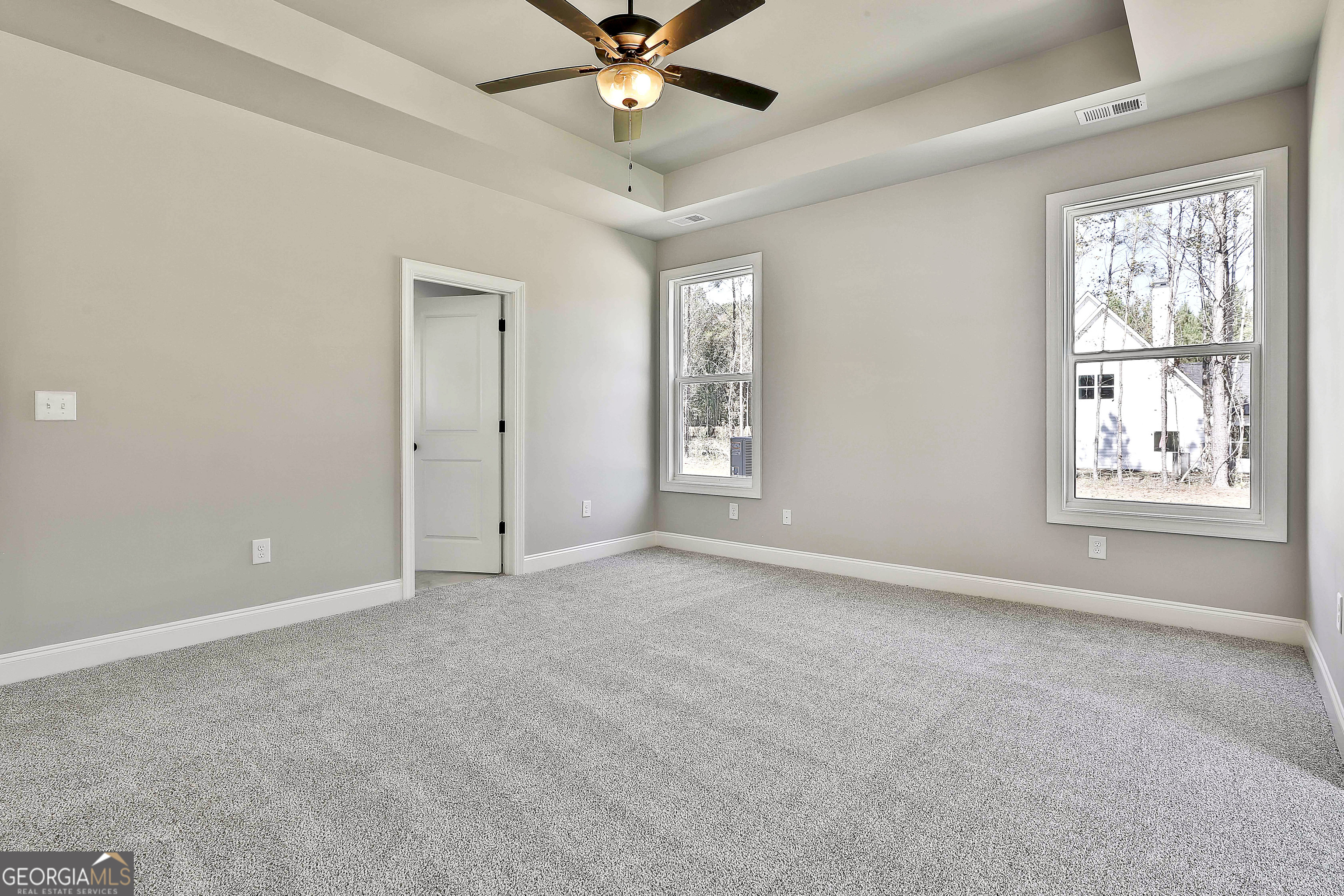 779 Alex Stephens Road Moreland, GA 30259 - Photo 32 of 54 an empty room with windows and fan