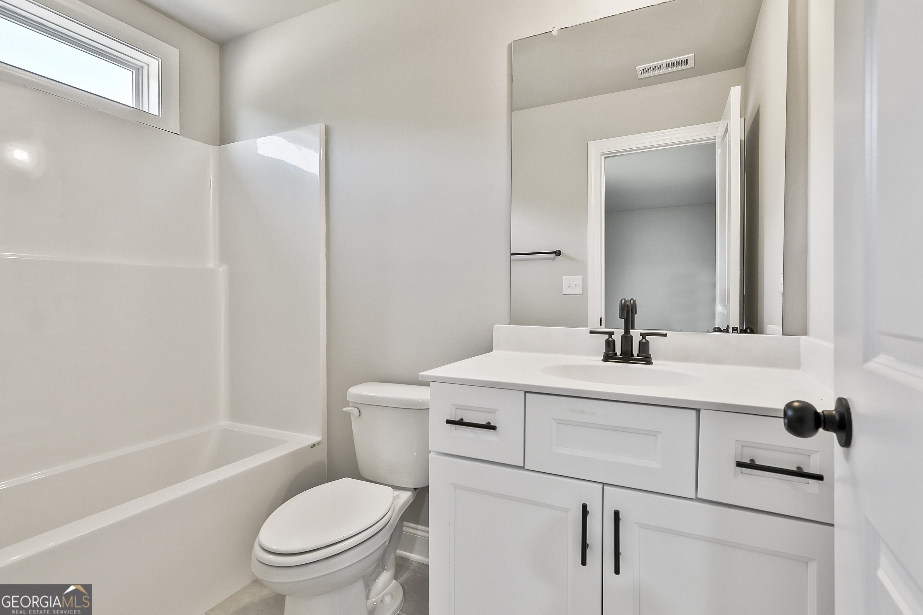 779 Alex Stephens Road Moreland, GA 30259 - Photo 42 of 54 a bathroom with a toilet sink vanity tub and shower