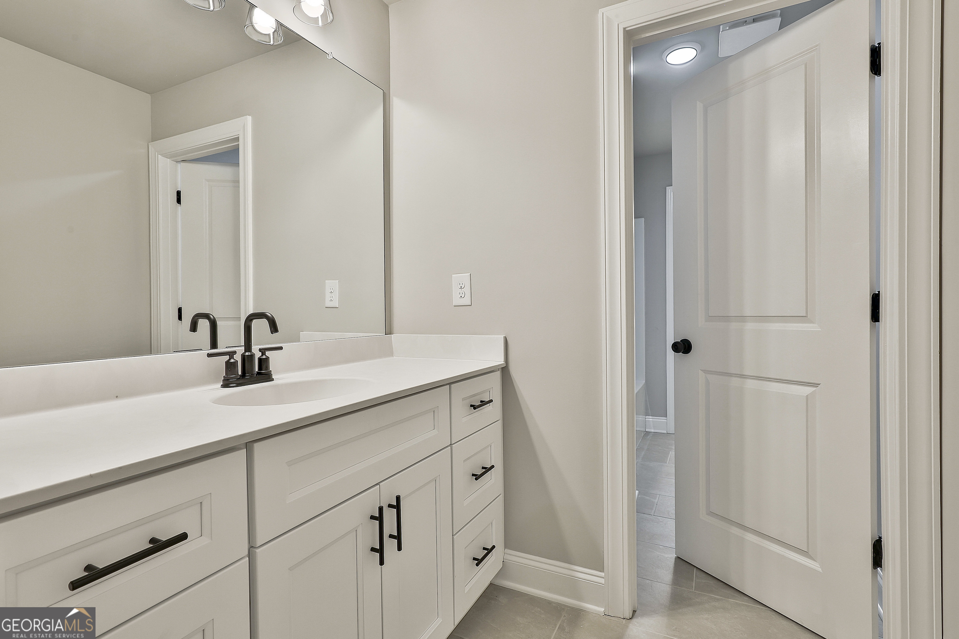 779 Alex Stephens Road Moreland, GA 30259 - Photo 48 of 54 a bathroom with a double vanity sink and a mirror