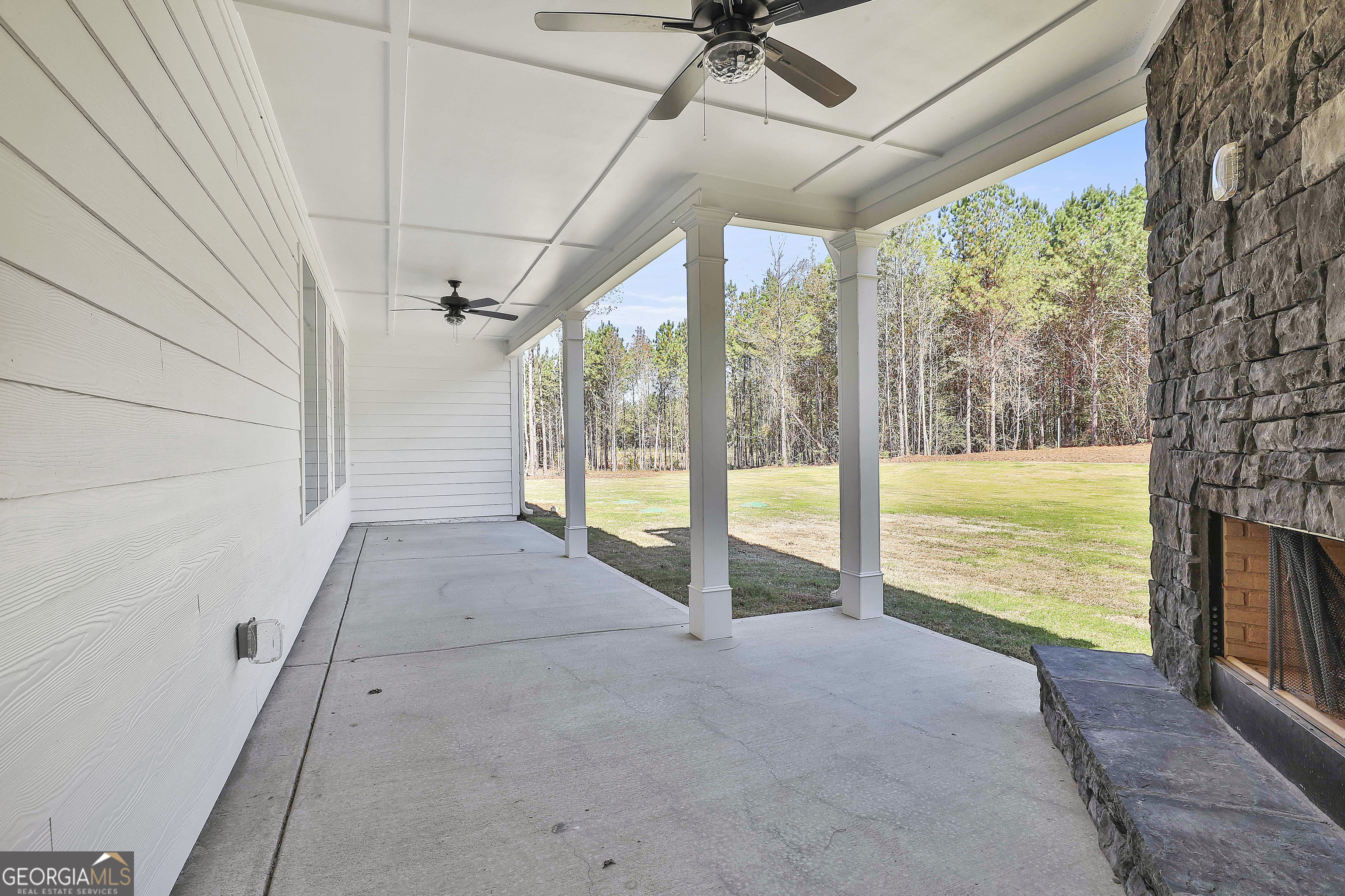 779 Alex Stephens Road Moreland, GA 30259 - Photo 49 of 54 a view of an empty room with a fireplace and windows
