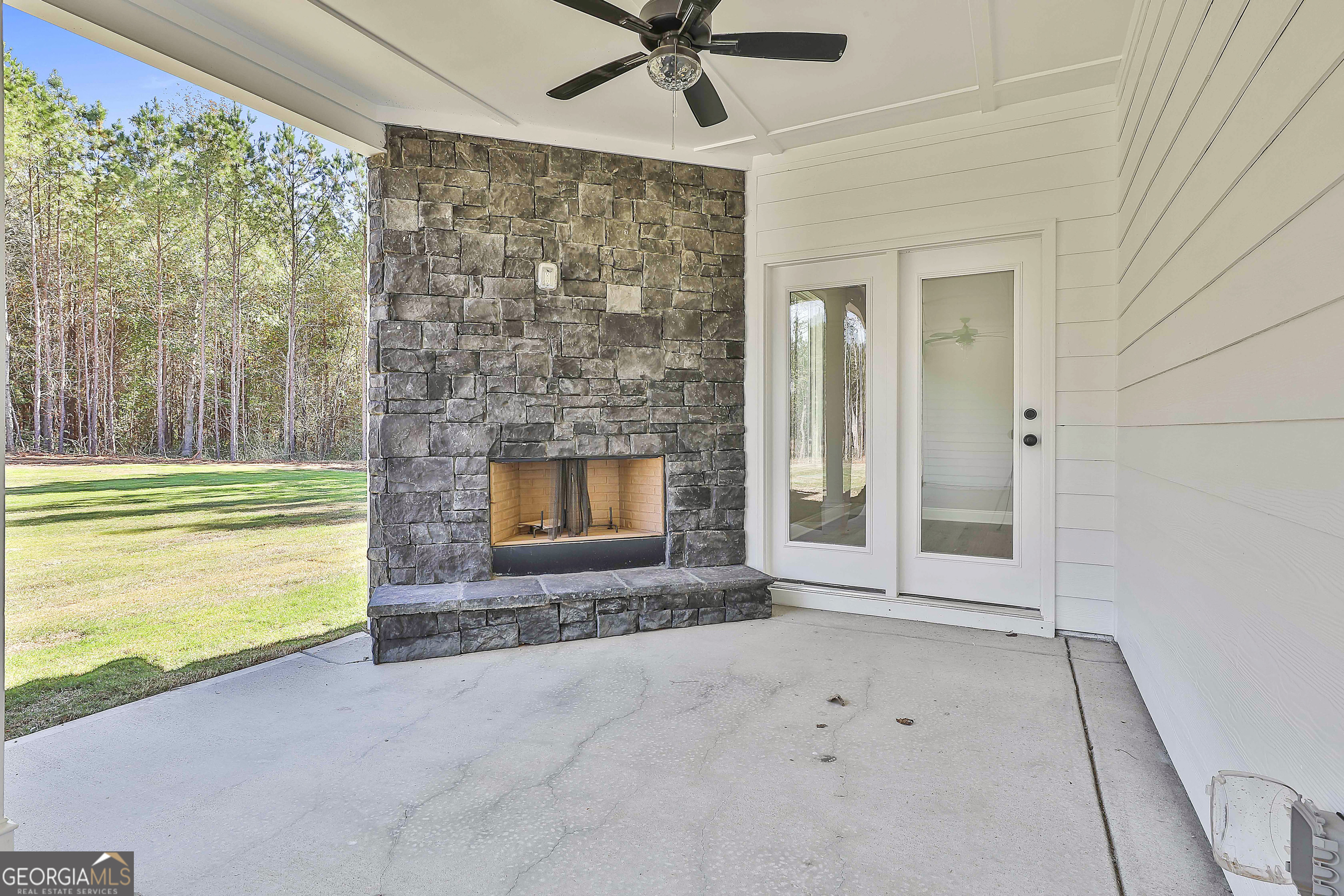 779 Alex Stephens Road Moreland, GA 30259 - Photo 50 of 54 a living room with a fireplace and a floor to ceiling window