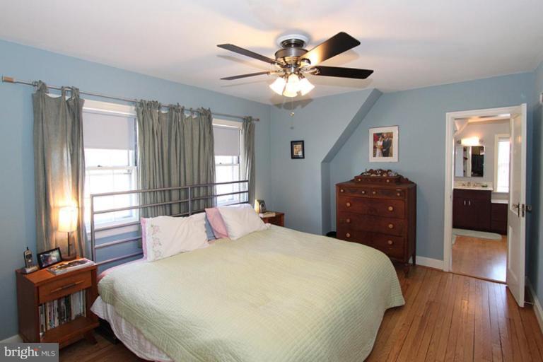804 Rowen Road Silver Spring, MD 20910 - Photo 18 of 22 a bedroom with a large bed and a chandelier