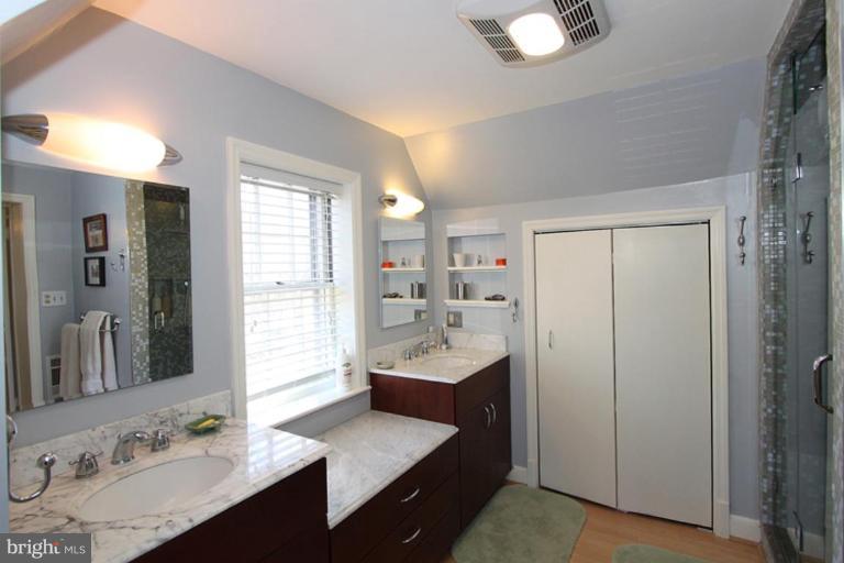 804 Rowen Road Silver Spring, MD 20910 - Photo 19 of 22 a bathroom with a sink double vanity and a mirror