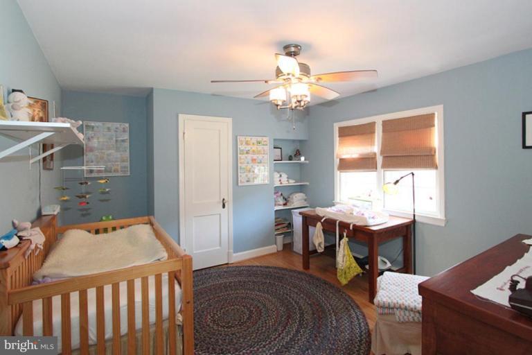 804 Rowen Road Silver Spring, MD 20910 - Photo 4 of 22 a bedroom with a bed and a chandelier